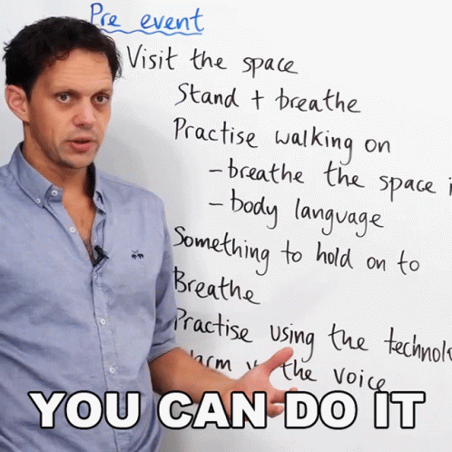 a man standing in front of a whiteboard and talking