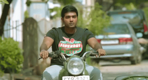 a man in black shirt riding on a motorcycle
