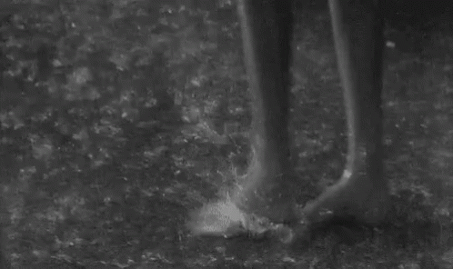 a person's legs in the dirt while standing up
