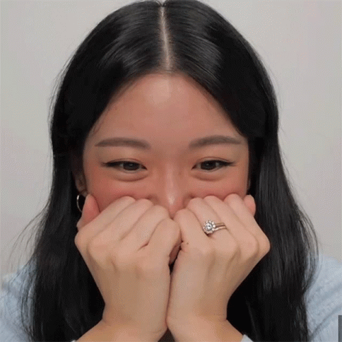 an attractive woman covering her eyes with her hands