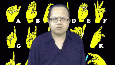 a po of a man making a weird face in front of a black background with different hand gestures