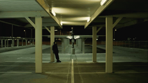 a person standing under an overpass in the dark