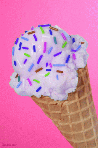 a ice cream cone with a sprinkle covered in frosting