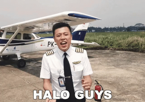 a man standing outside next to an airplane with halo guy's hair