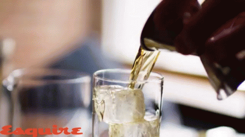 a woman is pouring soing into a glass of ice