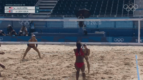 some people are playing volleyball on a beach