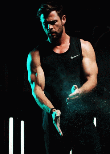 man wearing black tank top and holding ball on stage