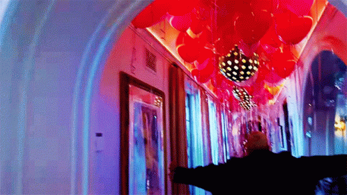 a man standing under the decorations on the ceiling