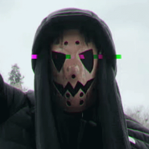 guy with a full mask on in the dark