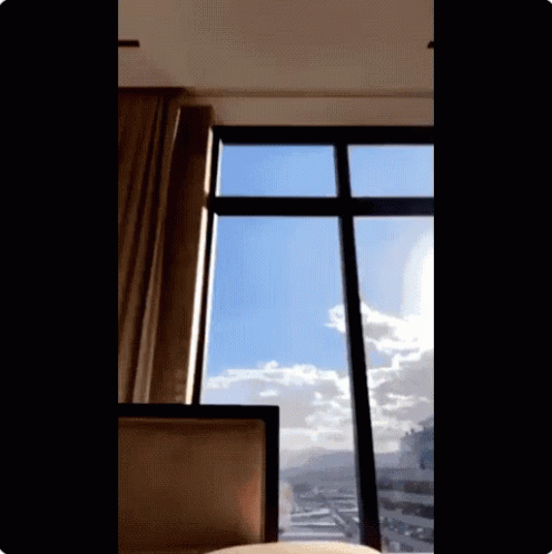 a window with curtains open in the evening