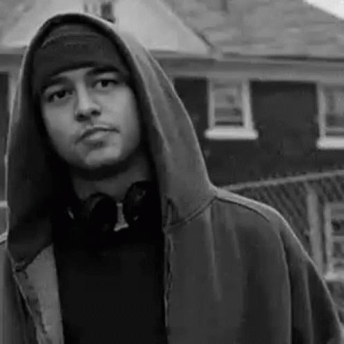 a young man with a hoodie staring into the camera