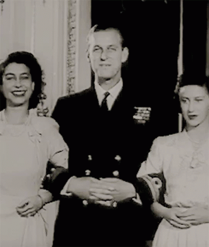 a man and two women are standing next to each other