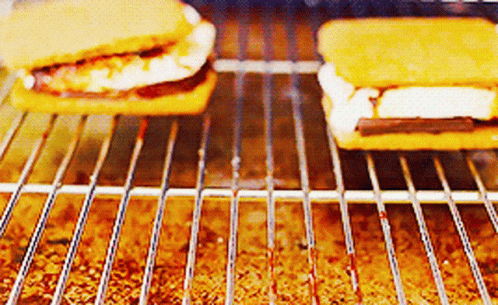 two blue cake like items are cooking in an oven