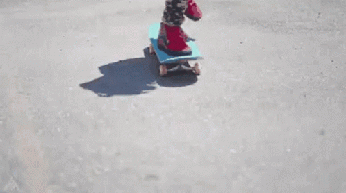 a child riding on a skateboard down the street