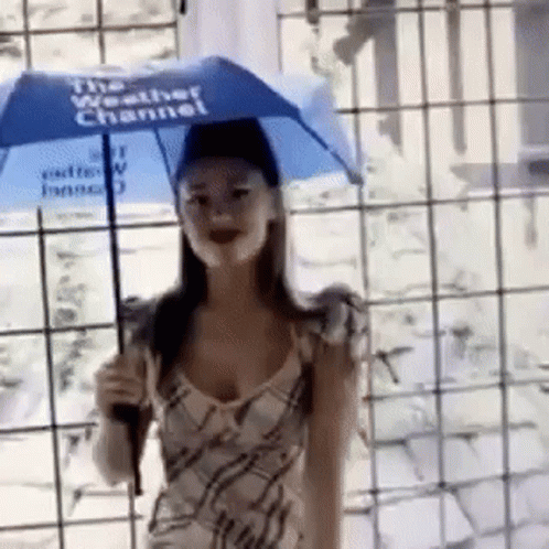 a woman is smiling as she holds an umbrella