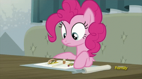 a pink pony sitting at a table with some glasses