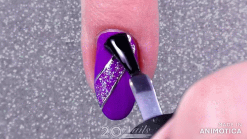 a woman with purple nail polish getting ready to remove her nails