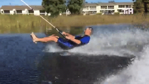a water skier is falling off of a boat