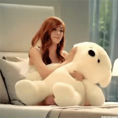 a person is holding a white stuffed animal
