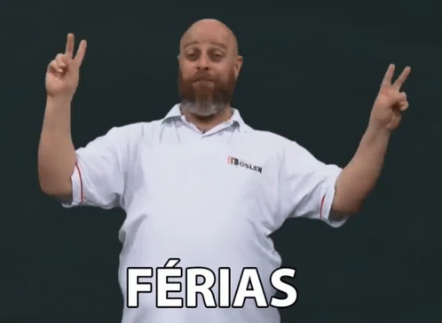 a man standing with both hands up and saying ferias