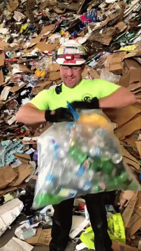 a person standing on a pile of trash in a yard with one leg up