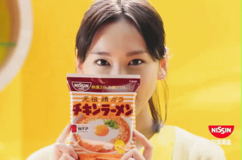 asian woman with mask holding up packet of vitamin cq