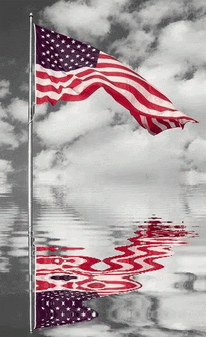 a american flag flying next to a body of water