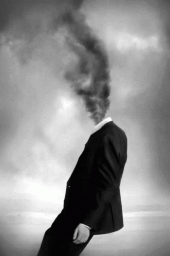 a man in a suit and tie walking away from the camera, with a plume of smoke coming from his forehead