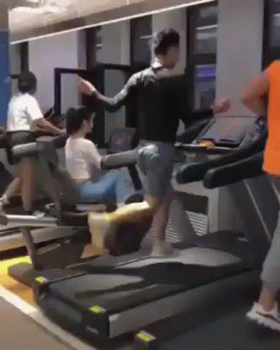 people walking and riding stationary exercise equipment in a gym