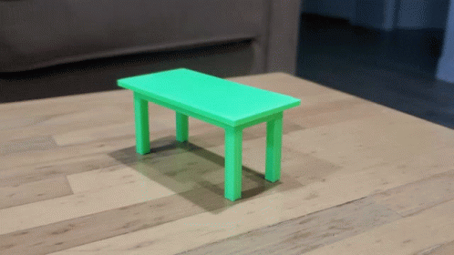 small wooden toy table on white floor in front of couch