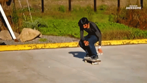 a boy performs tricks on his skateboard