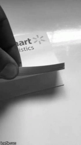 a person holding up a business card with a on