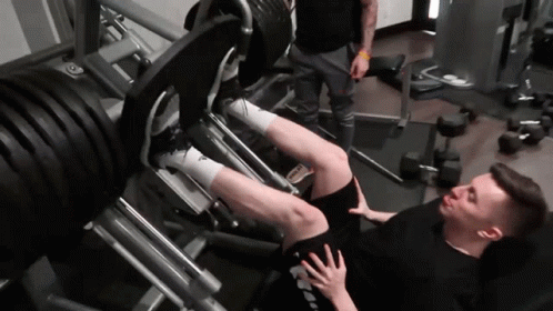 a man doing squats on a bench in a gym