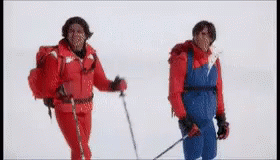 three people are on skis while they are wearing blue