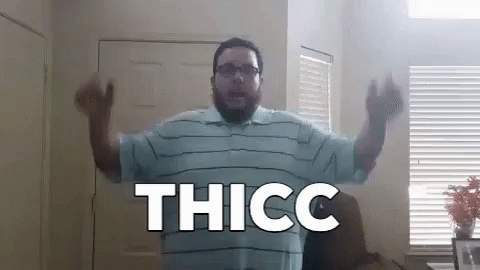 a man stands in front of a computer monitor with text reading thicc