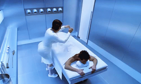 two people in white and white bath robes putting soing on the bed