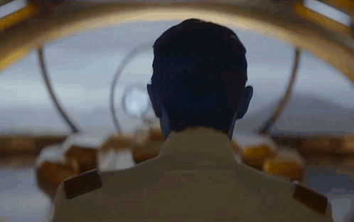 the back end of a man's head in a futuristic port