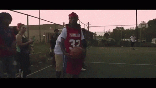 a basketball player walks to his teammate in the court