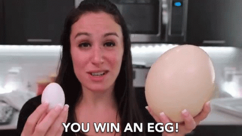 a woman holding an egg that is on top of her arm
