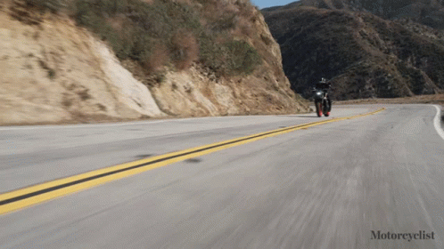 a person is riding a motorcycle down a hill