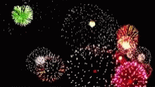 fireworks and colorful lights that are glowing against a black sky
