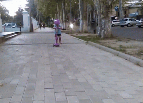a person riding a skate board on a city street