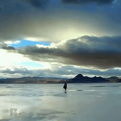 a man standing in the middle of a frozen lake