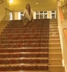 a woman sitting on some steps in an auditorium