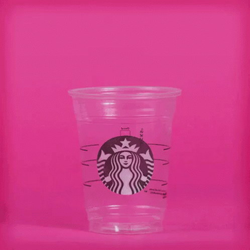 a glass cup with a picture on the lid on a purple background