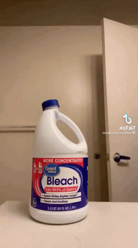 a bottle of bleach next to a mirror