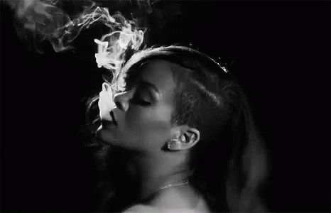 a woman is smoking cigarettes and making an expression