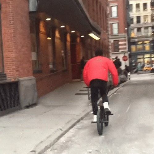 person on bicycle in the middle of an alley