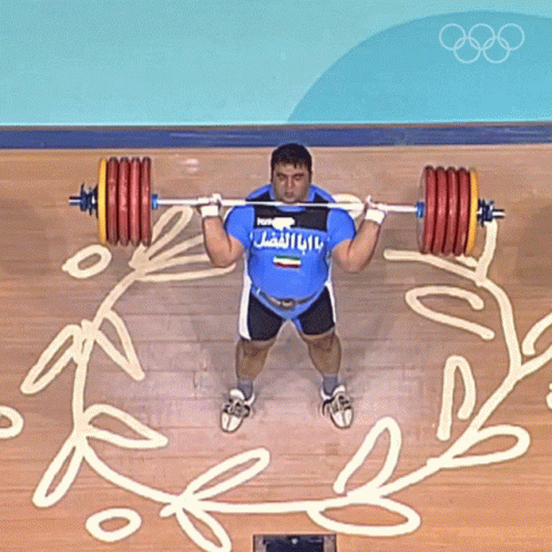 a man is lifting two blue and yellow weights