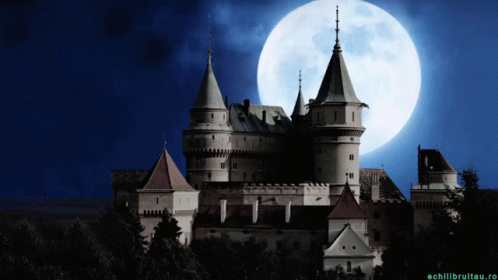 a castle with a large full moon behind it
